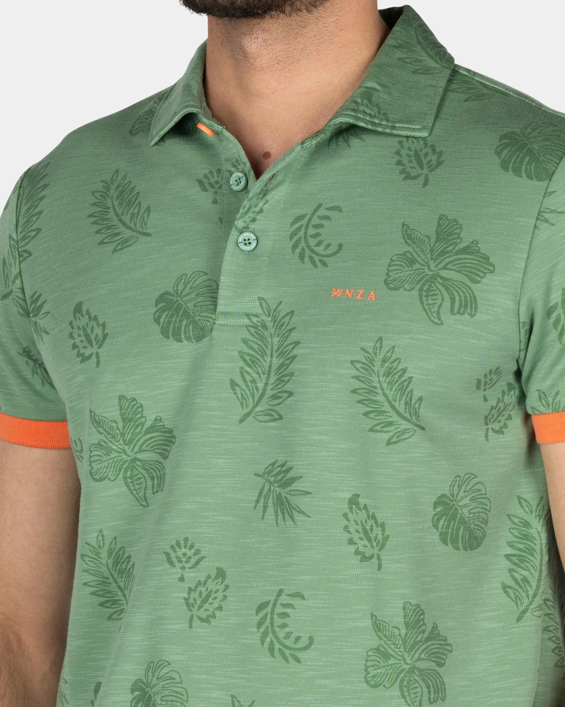 Green polo shirt with leaf print