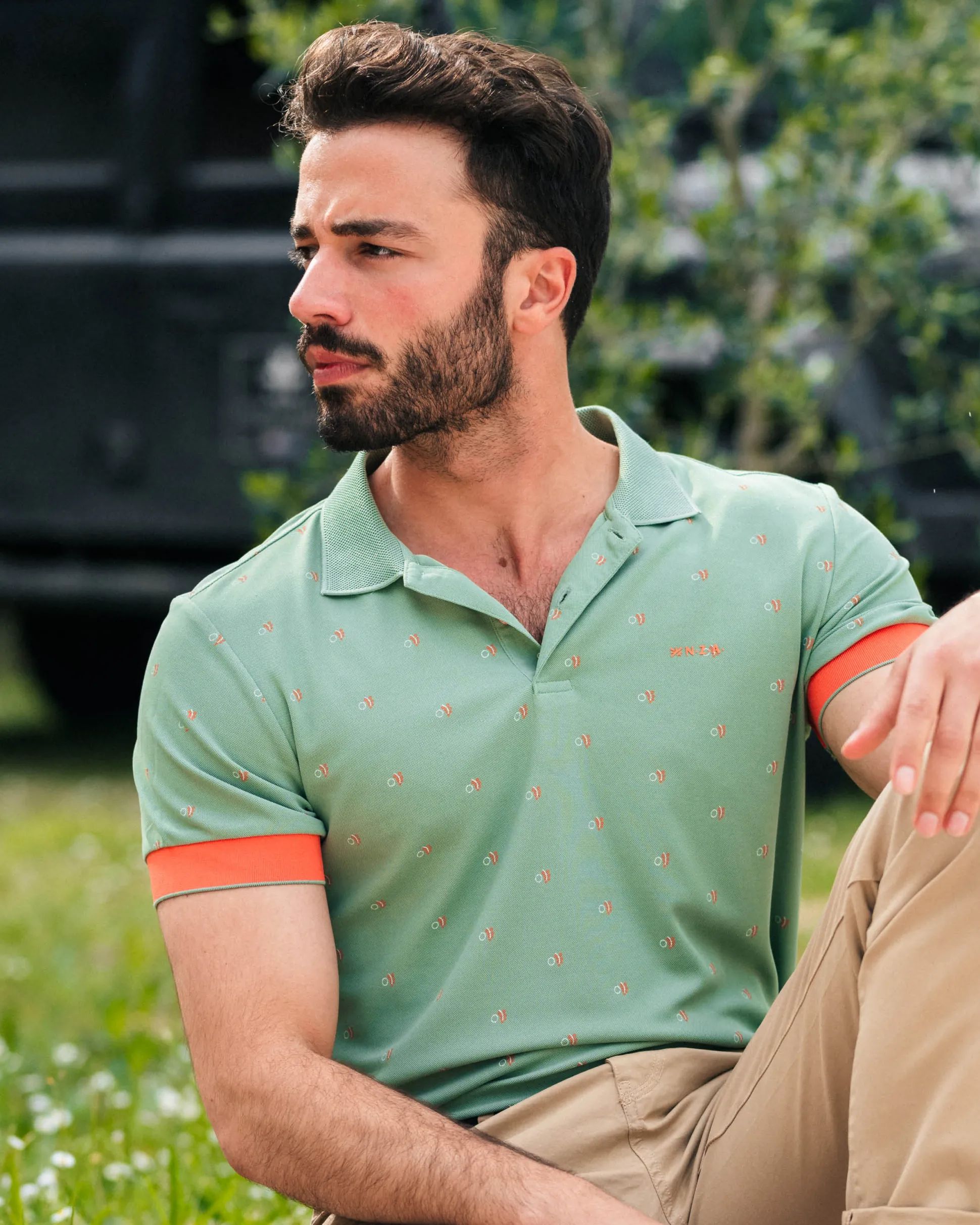 Green polo with orange accents