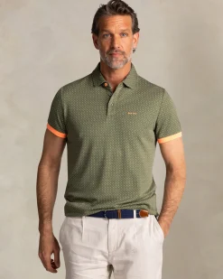 Green polo with small orange dots