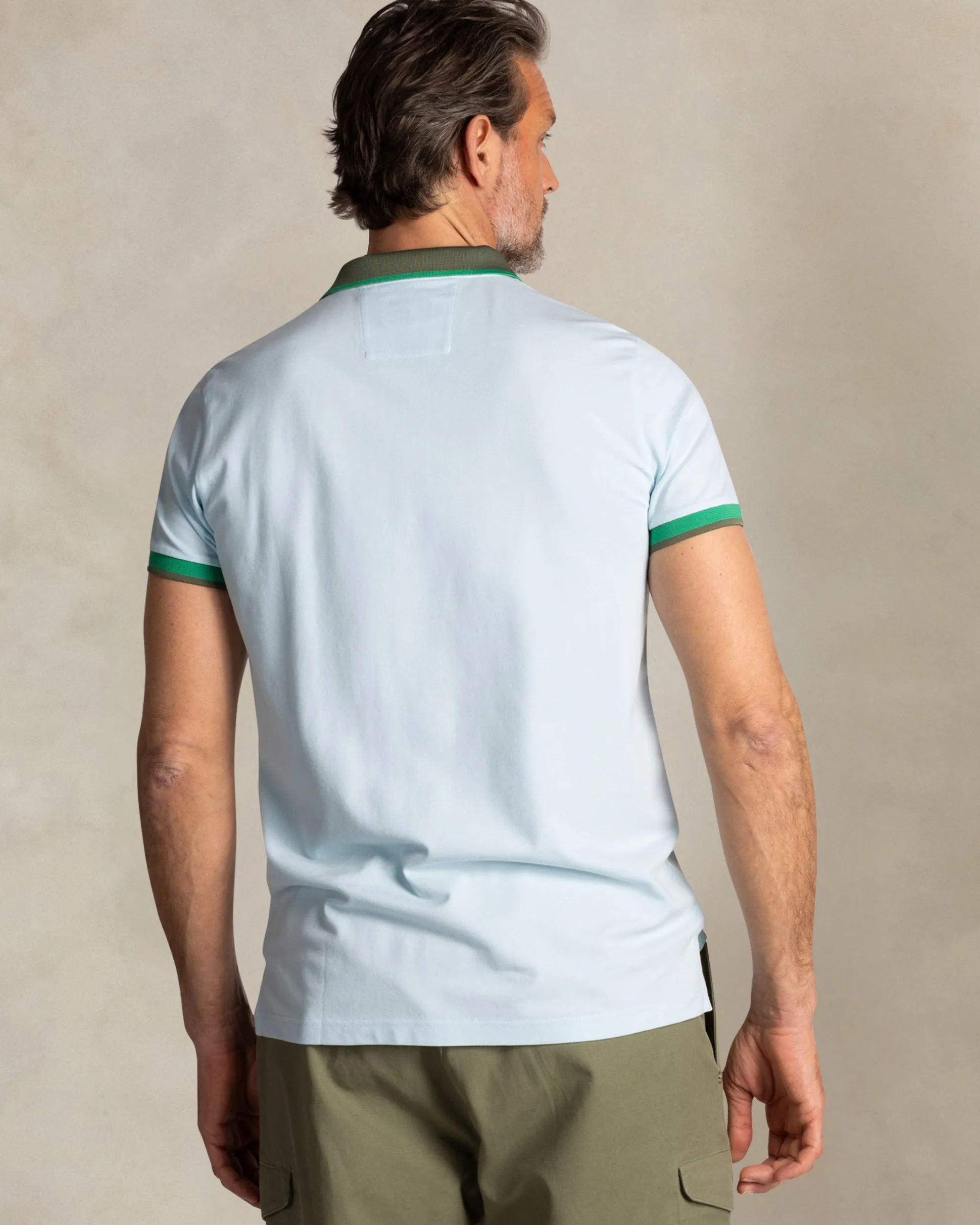 Light blue cotton polo with green collar