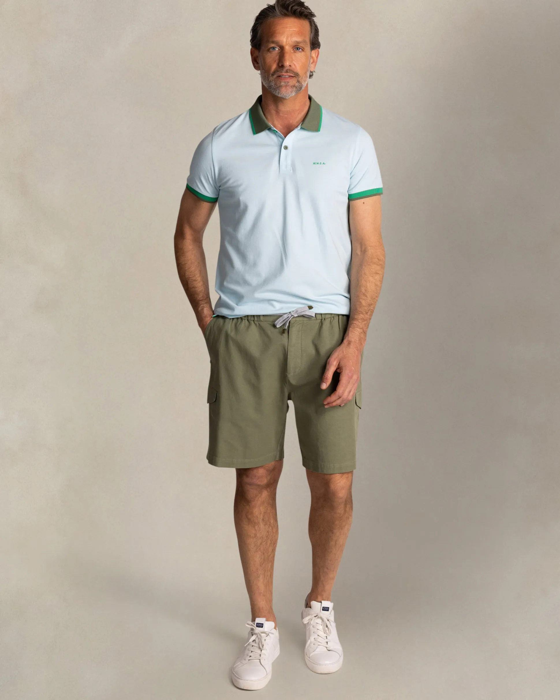 Light blue cotton polo with green collar