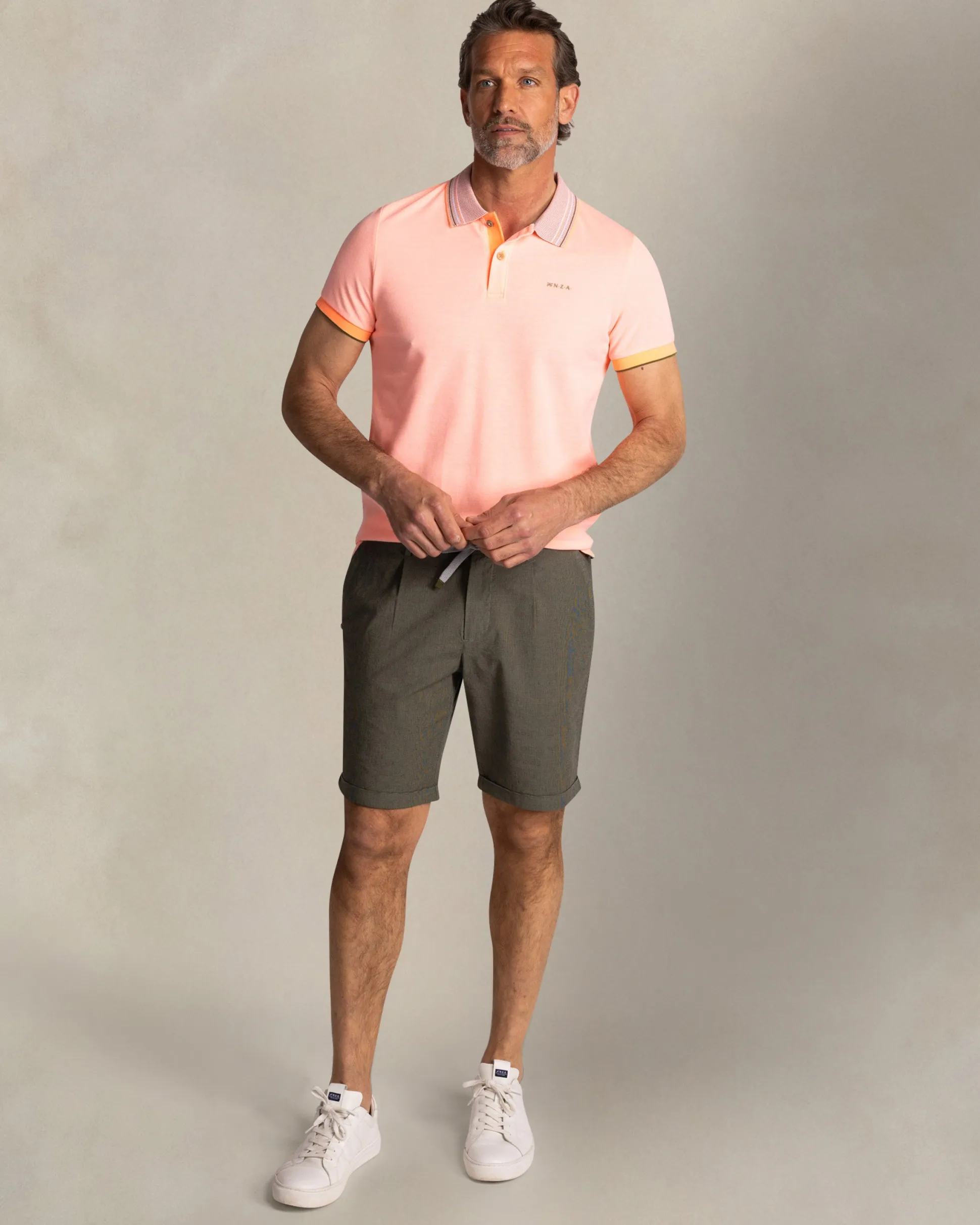 Orange polo with striped collar
