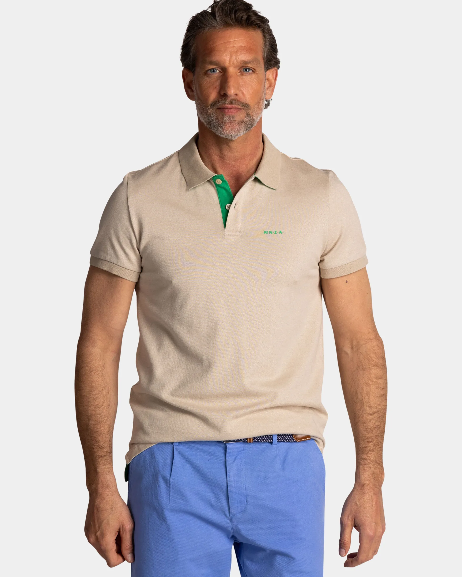 Solid light brown polo with green details